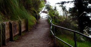 a fenced trail leads up and around a bend