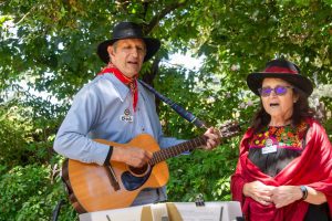 Two musicians singing outside of the Castro Adobe