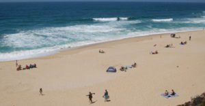 Montara beach visitors walking and sunbathing on the sand