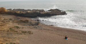 Waves crash against a rock outcropping on Pebble beach