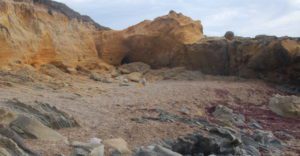 a rocky, sand-filled cove