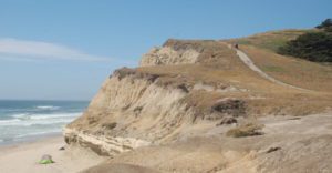 a trail leads up a bluff over the ocean