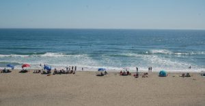 beach visitors playing in the ocean at Manresa State beach