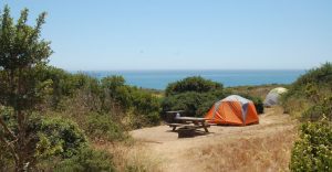 bright orange tent and picnic table at Manresa Uplands