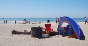 Seabright beach with a tent and popup chairs