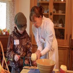 woman helps child cut an apple