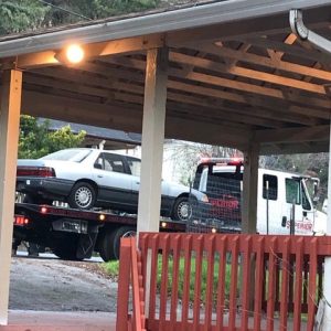 a car being abducted by a tow truck