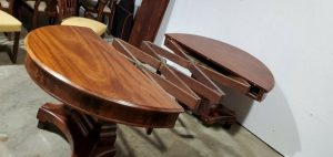 a round wooden dining table expanded in the center to allow more tiers