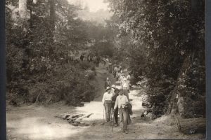 group of people walking along a path, black and white