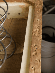 old, chipped wood supported by a new plank of wood