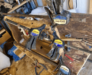 wood clamps hold together the wooden sides of a couch