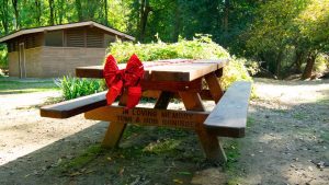 A tribute table with a red bow on it