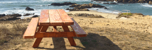 A picnic table on a bluff overlooking the ocean