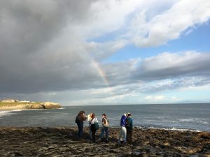 Tidepool Docents standing on a rock overlooking the ocean