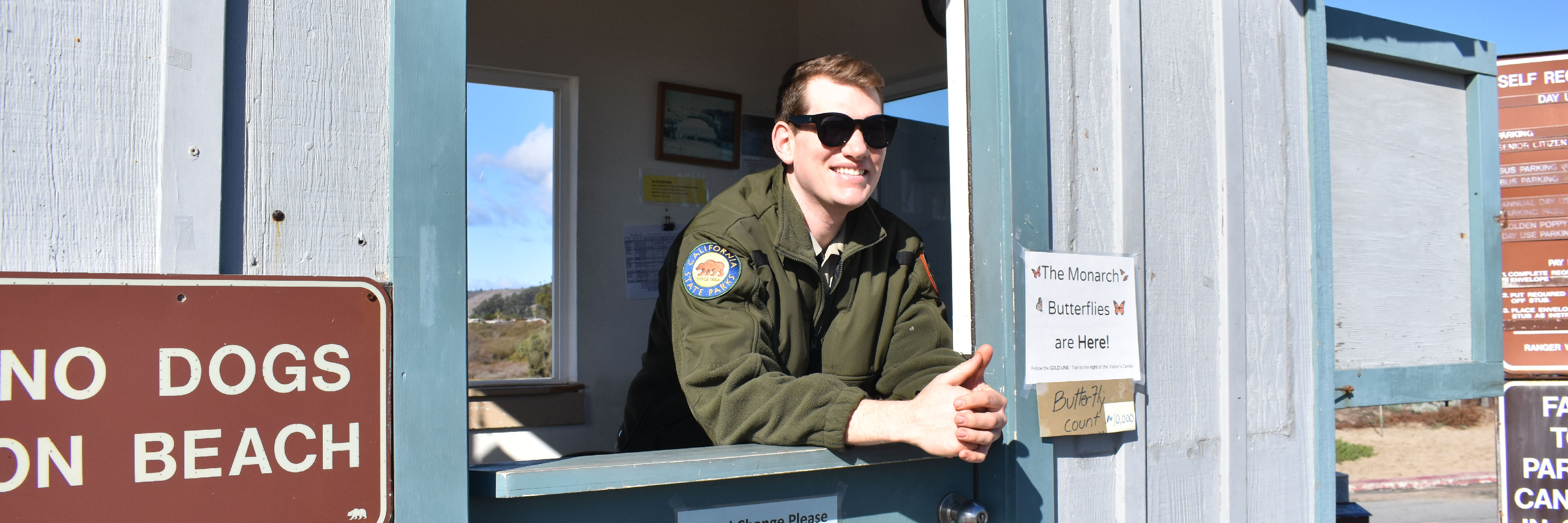 A state parks employee at a kiosk