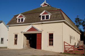A barn with a red door on a ranch