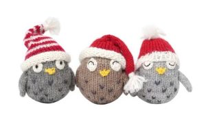 Three knitted birds in santa hats
