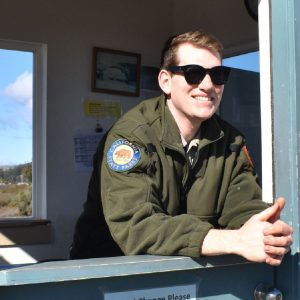 A parks service worker leaning out of a booth